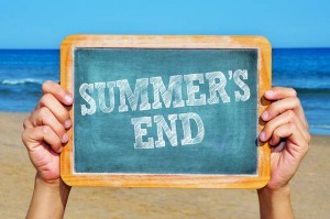 someone holding a blackboard with the sentence summers end writt
